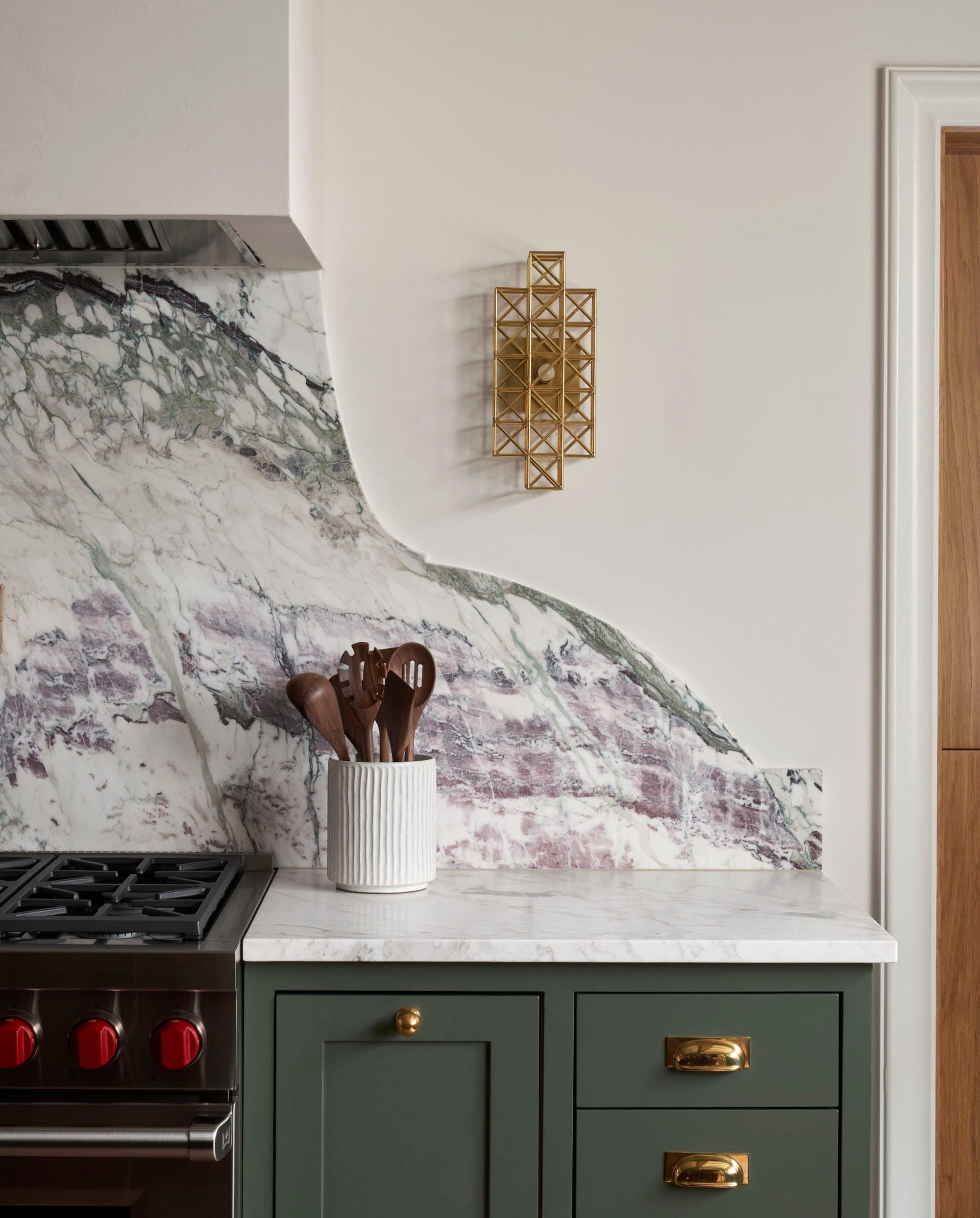 Kitchen with gold-accented cabinetry and marble at The Beverly Casa